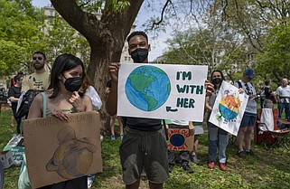 FILE - Activists display placards during a rally to mark Earth Day the day prior, April 23, 2022, at Lafayette Square in Washington. More than 190 countries celebrate Earth Day on April 22 each year. It’s an event that originated in the United States more than 50 years ago with an idea from a junior senator from Wisconsin — Gaylord Nelson. (AP Photo/Gemunu Amarasinghe, File)